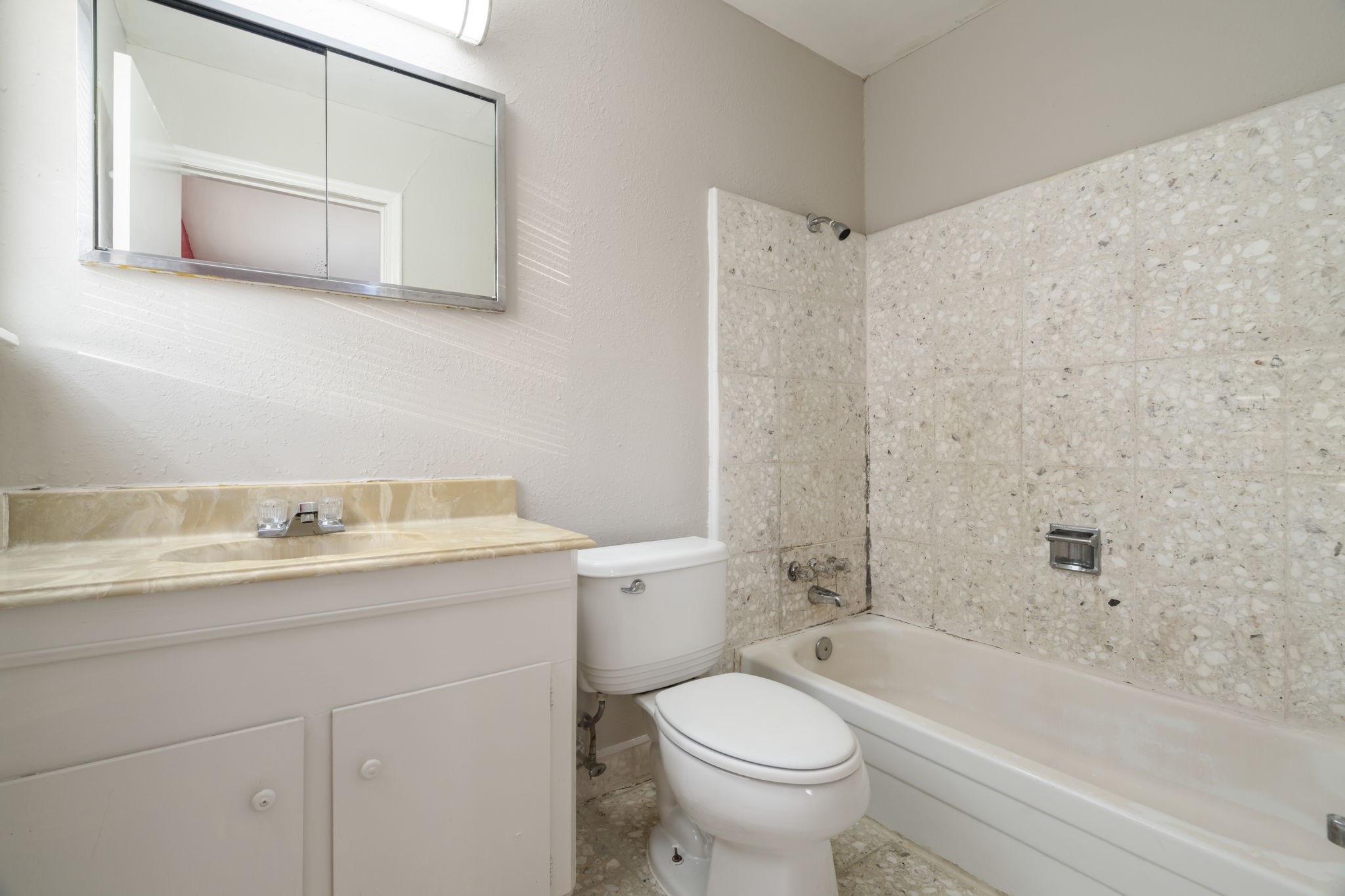 11607 Chimney Rock Road, Unit C Houston, TX 77035 - Photo 16 of 18 a bathroom with a granite countertop sink a toilet and bathtub