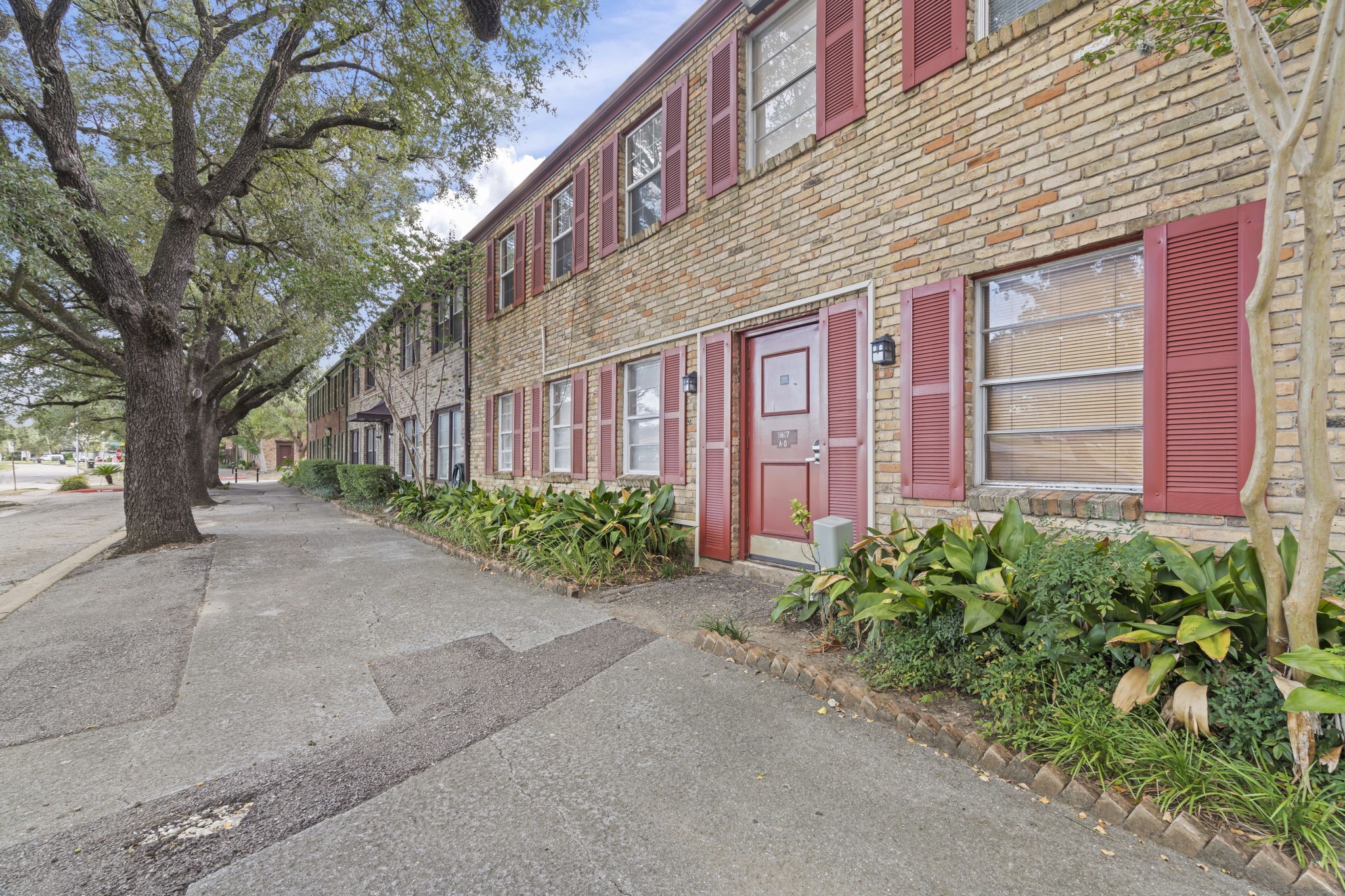 11607 Chimney Rock Road, Unit C Houston, TX 77035 - Photo 3 of 18 a view of a building with a garden