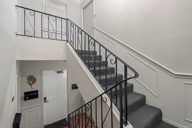 a view of entryway and hall with wooden floor