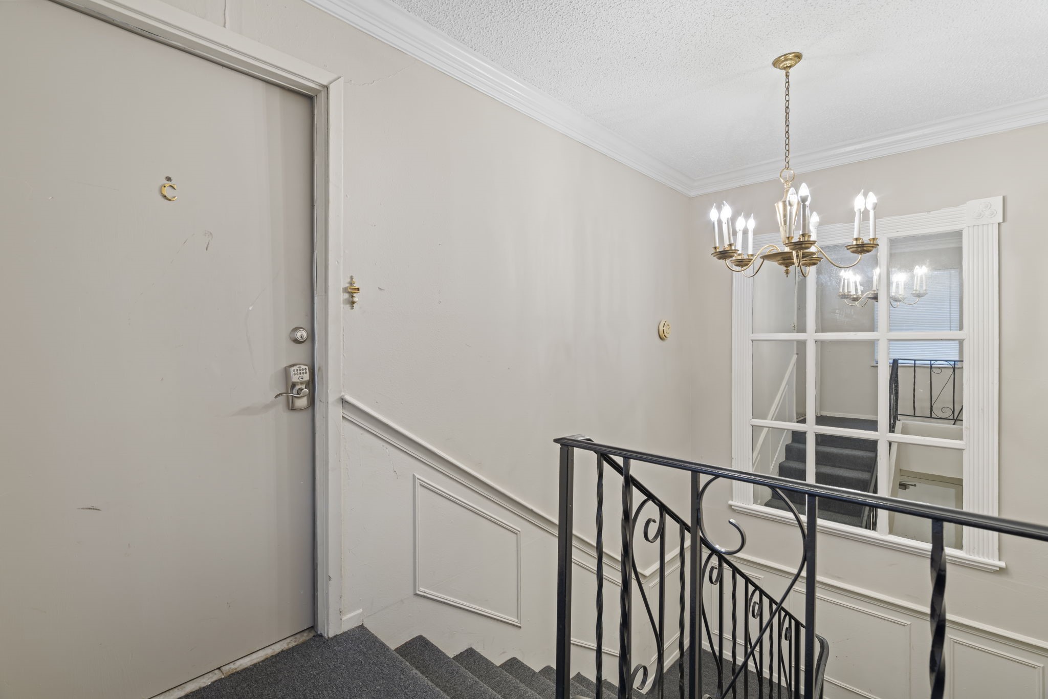 11607 Chimney Rock Road, Unit C Houston, TX 77035 - Photo 5 of 18 a view of a hallway with chandelier and entryway