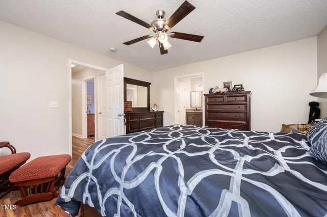 a bedroom with a bed and dresser