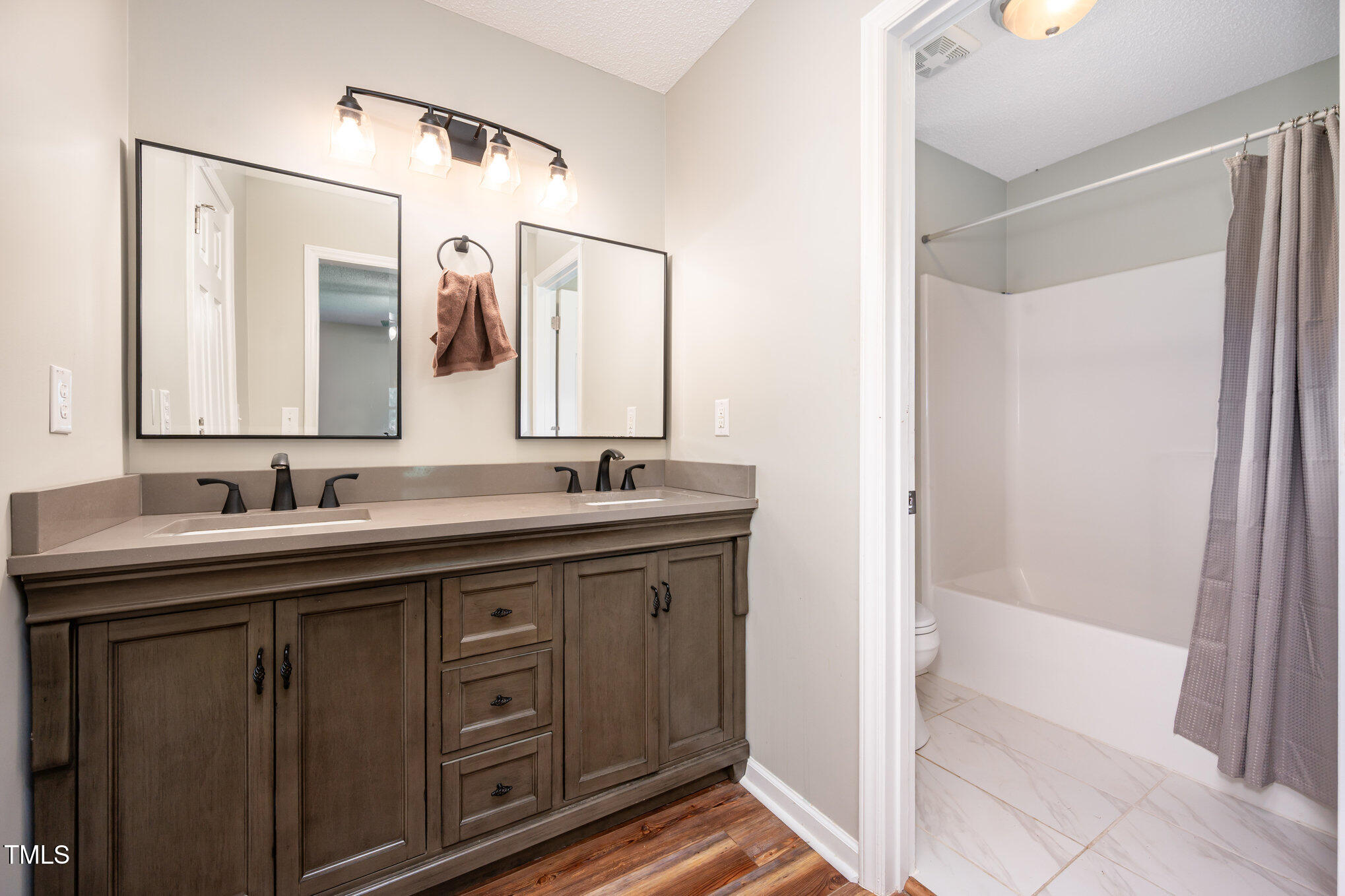 475 Jim Moore Road Timberlake, NC 27583 - Photo 12 of 26 a bathroom with a double vanity sink and mirror