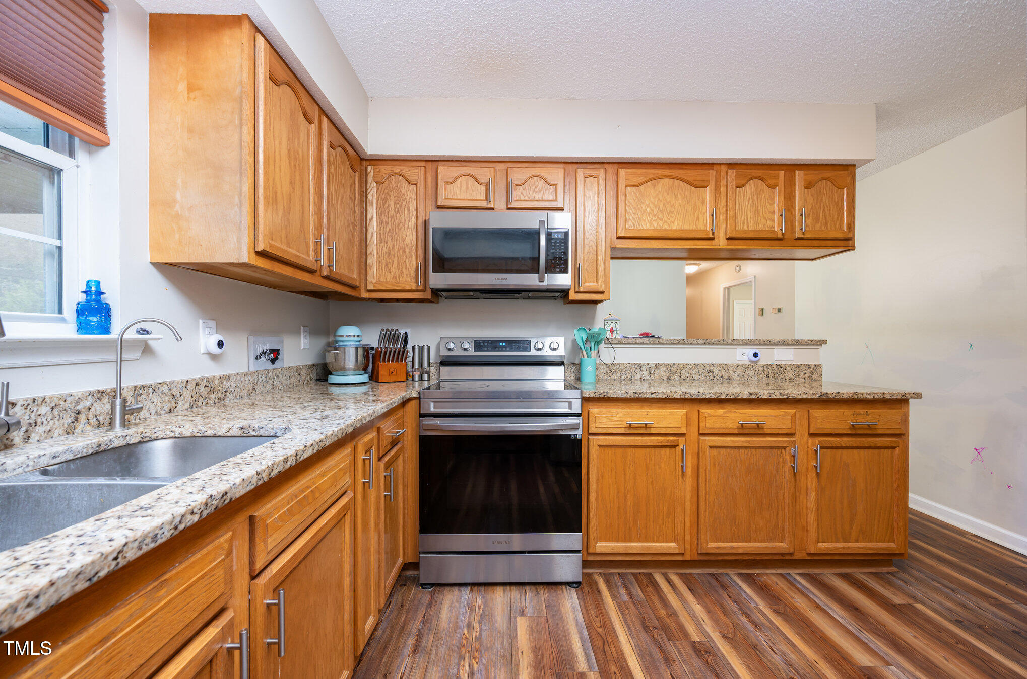 475 Jim Moore Road Timberlake, NC 27583 - Photo 5 of 26 a kitchen with stainless steel appliances granite countertop a sink stove and cabinets