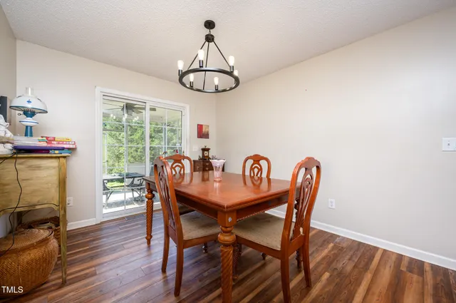 a view of a dining room with furniture wooden floor and chandelier
