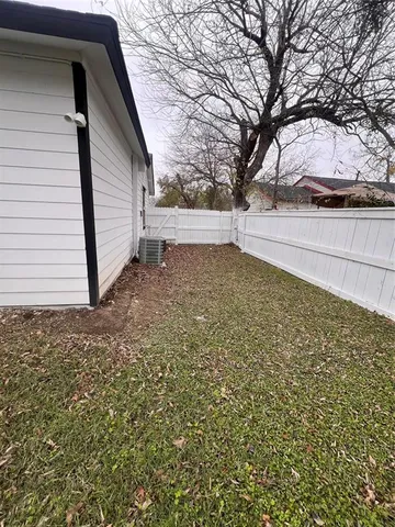 a view of a yard with large trees