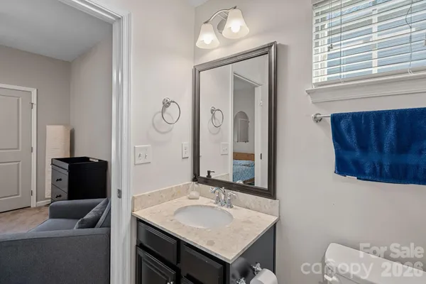a bathroom with a granite countertop sink and a mirror