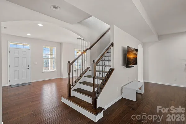 a view of entryway with wooden floor and stairs