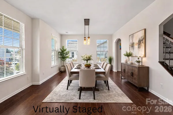 a dining room with furniture a rug and wooden floor
