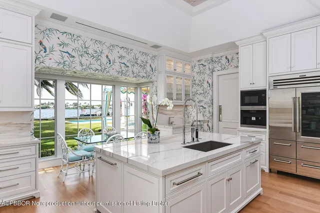 a kitchen with stainless steel appliances granite countertop a sink and a stove