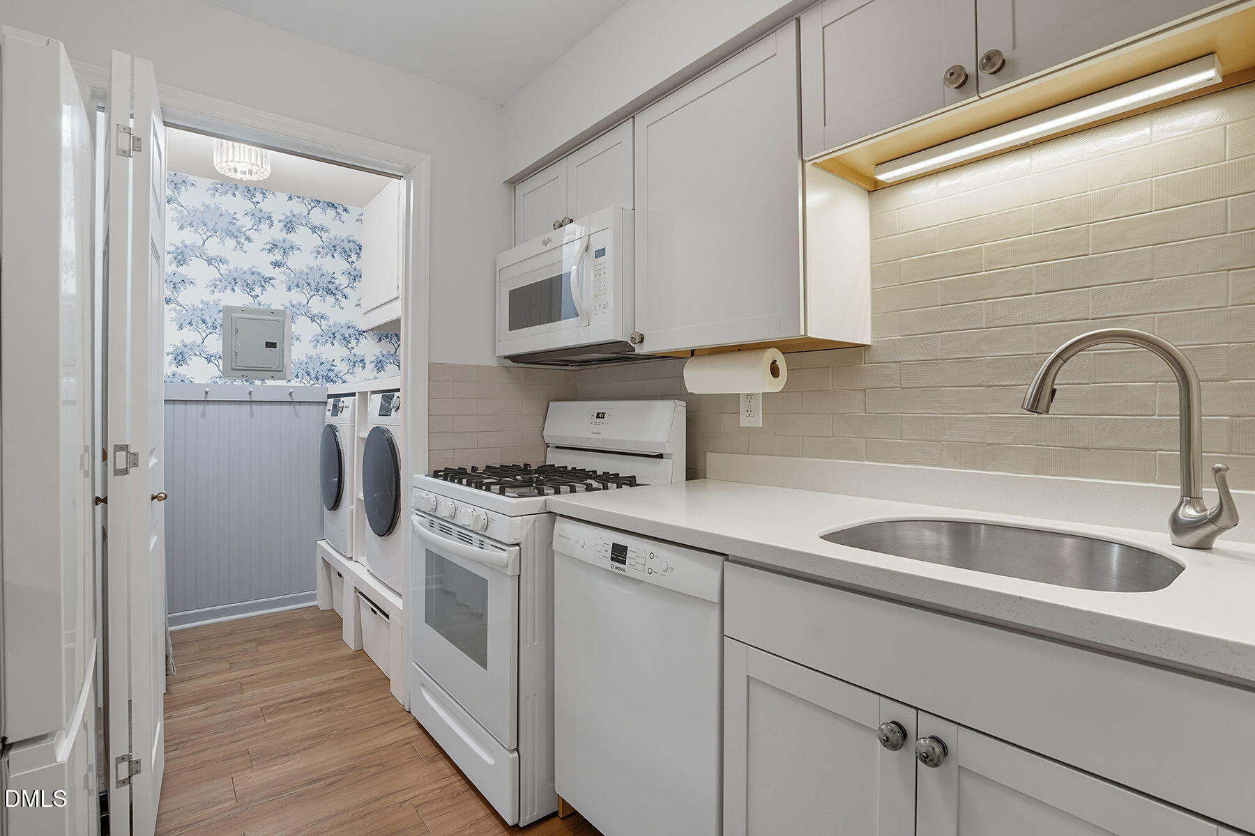 1308 Hillbrow Lane, Unit 203 Raleigh, NC 27615 - Photo 12 of 27 a kitchen with stainless steel appliances granite countertop a sink stove and refrigerator