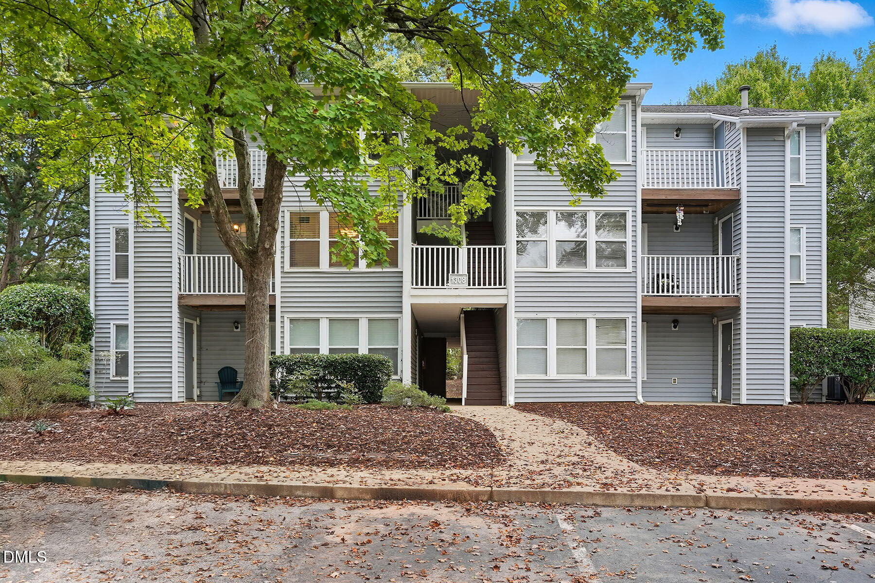 1308 Hillbrow Lane, Unit 203 Raleigh, NC 27615 - Photo 2 of 27 a front view of a house with a garden