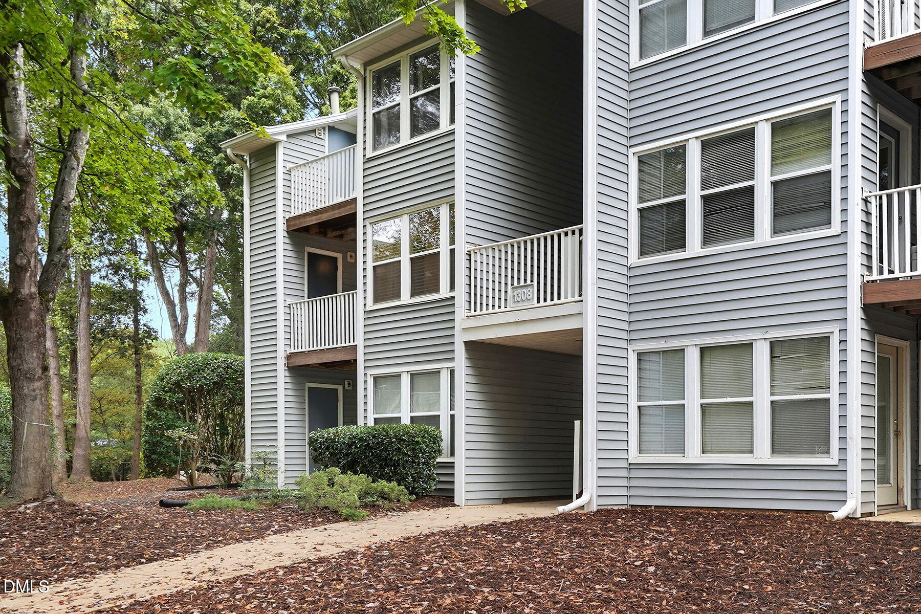 1308 Hillbrow Lane, Unit 203 Raleigh, NC 27615 - Photo 25 of 27 a front view of a house with a yard