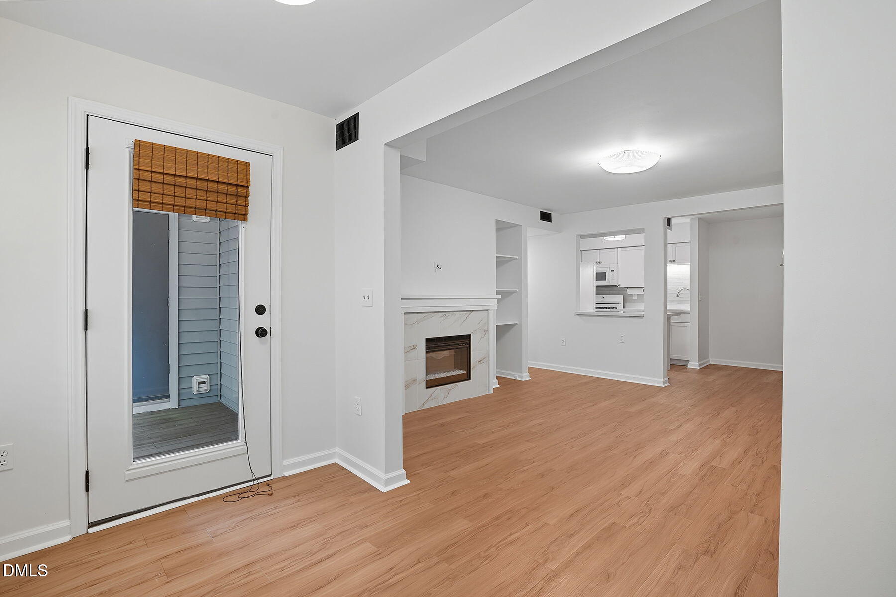1308 Hillbrow Lane, Unit 203 Raleigh, NC 27615 - Photo 7 of 27 a view of a livingroom with a fireplace wooden floor and windows