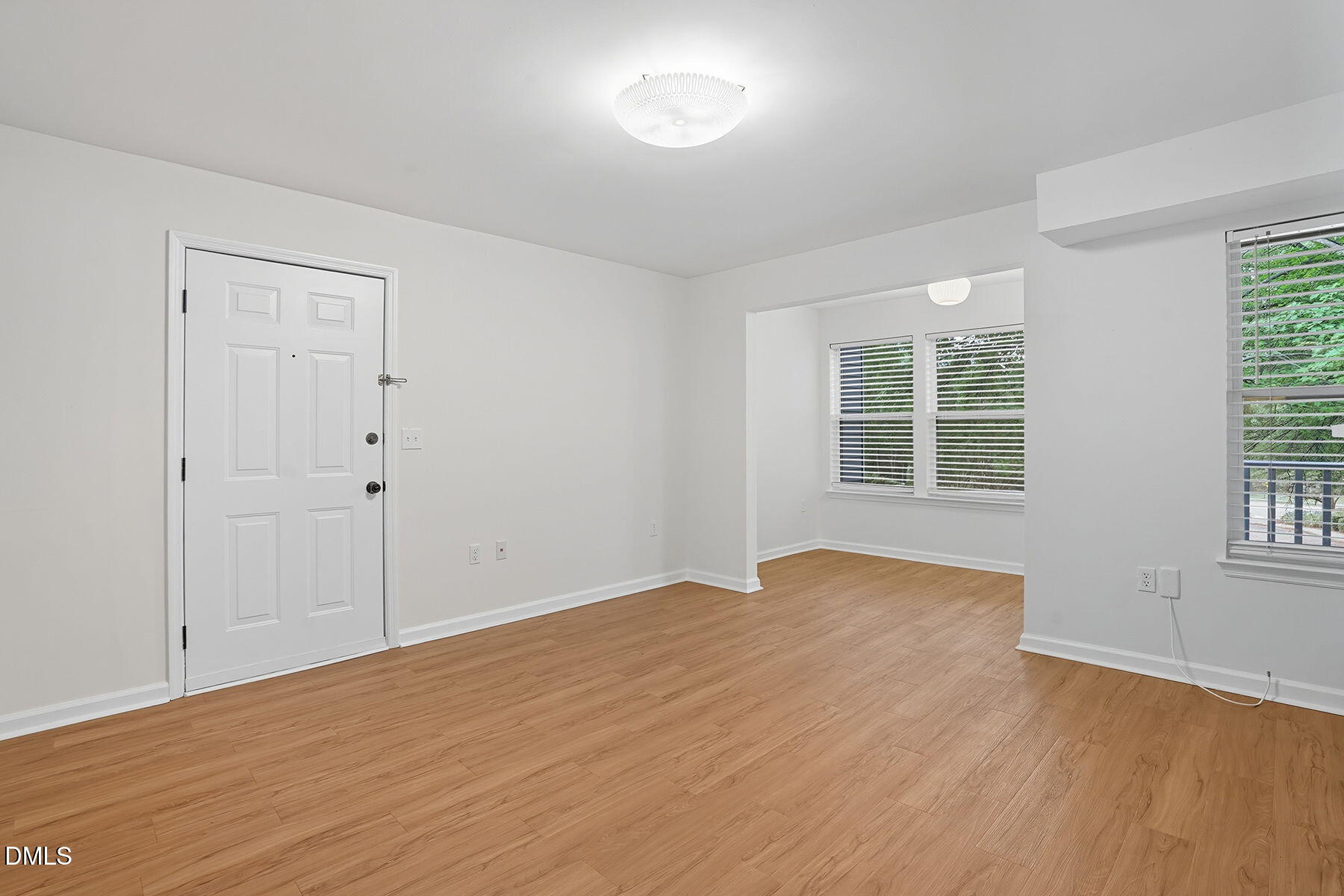 1308 Hillbrow Lane, Unit 203 Raleigh, NC 27615 - Photo 8 of 27 wooden floor in an empty room with a window