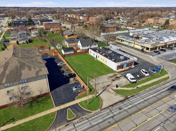 an aerial view of a residential houses with outdoor space