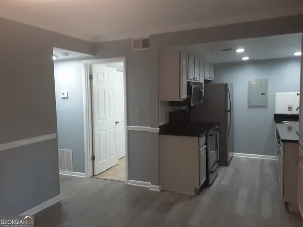 a kitchen with stainless steel appliances a refrigerator and a stove