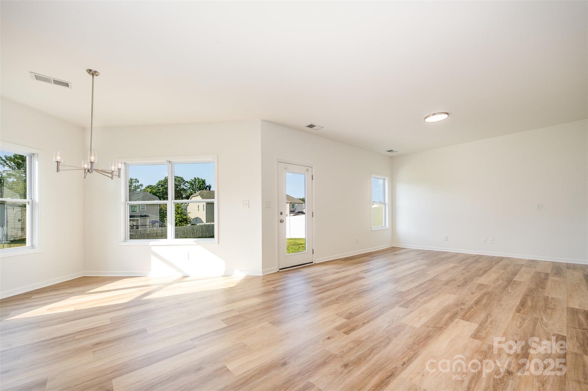 2206 Kingstree Drive Monroe, NC 28112 - Photo 3 of 25 a view of an empty room with wooden floor and a window