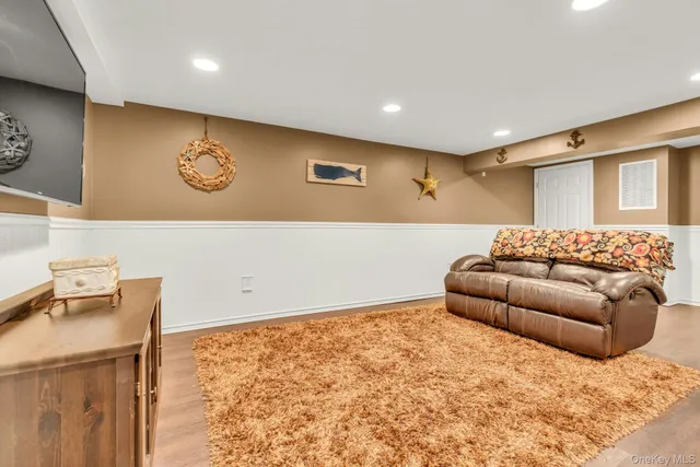 a living room with a couch and a stove with wooden floor