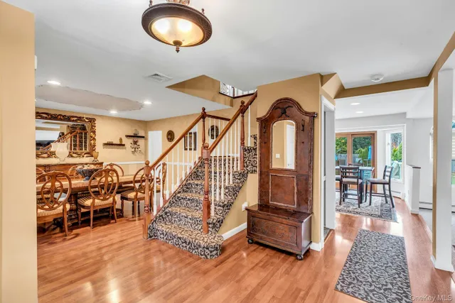 a view of entryway and hall with wooden floor