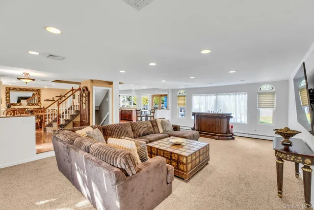 a living room with fireplace furniture and a flat screen tv
