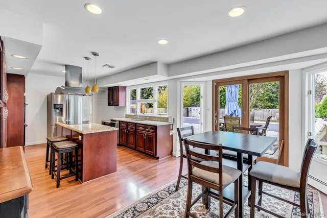 a dining room with a wooden table and chairs