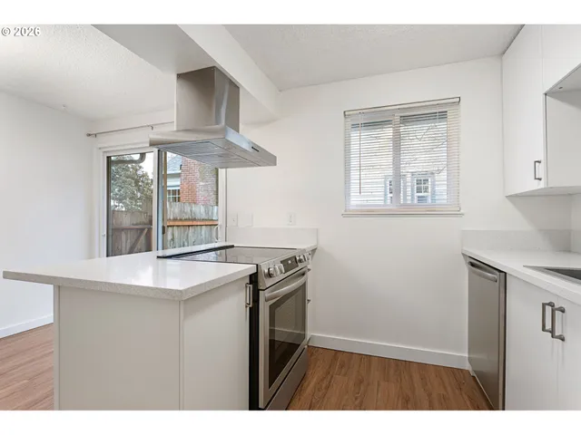 a kitchen with a refrigerator and a sink
