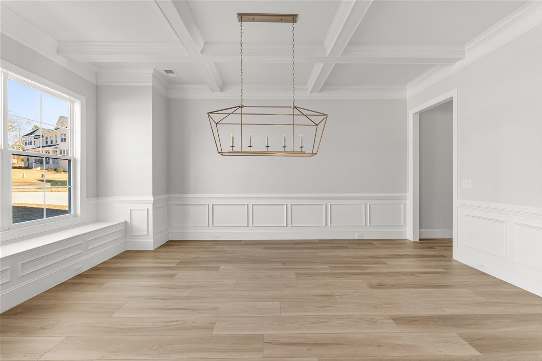141 Rickys Path Easley, SC 29642 - Photo 4 of 40 This bright and open room features elegant wainscoting and durable hardwood flooring.