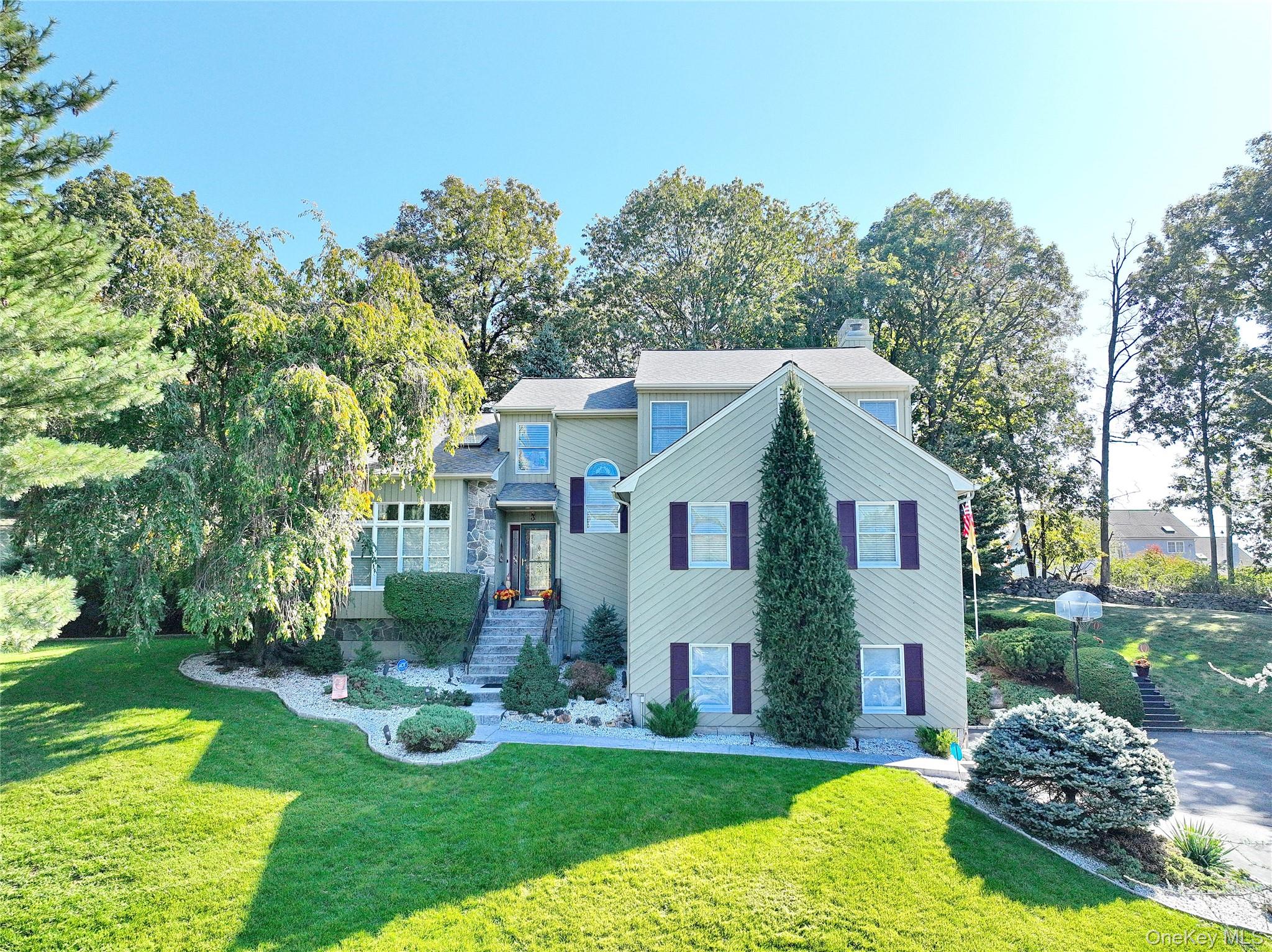 a front view of house with yard and green space