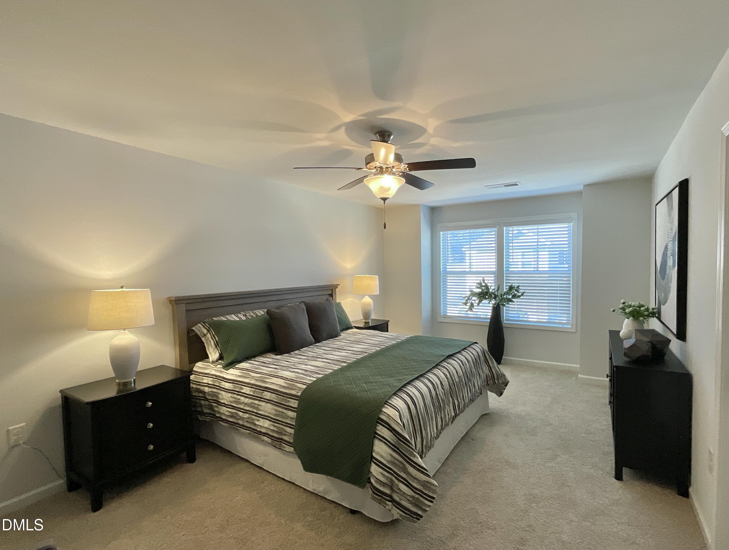 1135 Longitude Drive Durham, NC 27713 - Photo 18 of 37 a bedroom with a bed and a chandelier