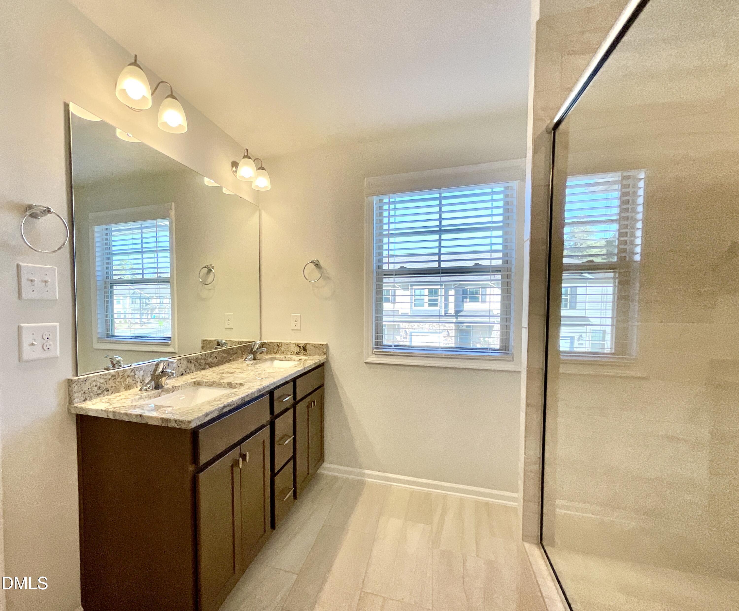 1135 Longitude Drive Durham, NC 27713 - Photo 20 of 37 a bathroom with a granite countertop sink and a mirror
