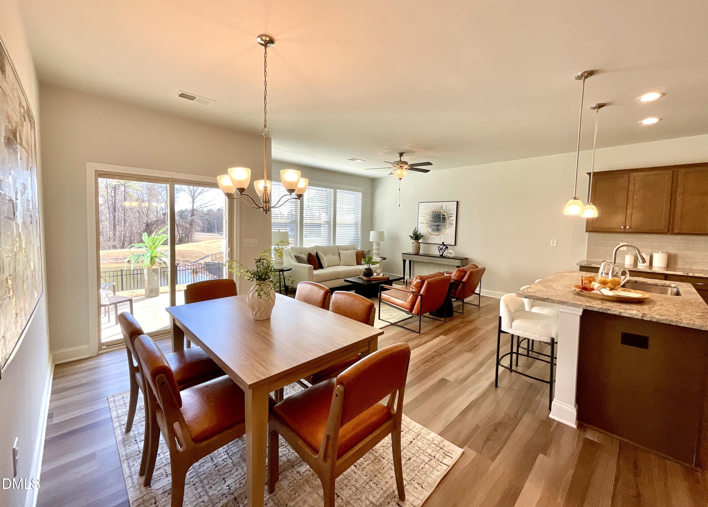 1135 Longitude Drive Durham, NC 27713 - Photo 6 of 37 a view of a dining room and livingroom furniture wooden floor a rug and a chandelier