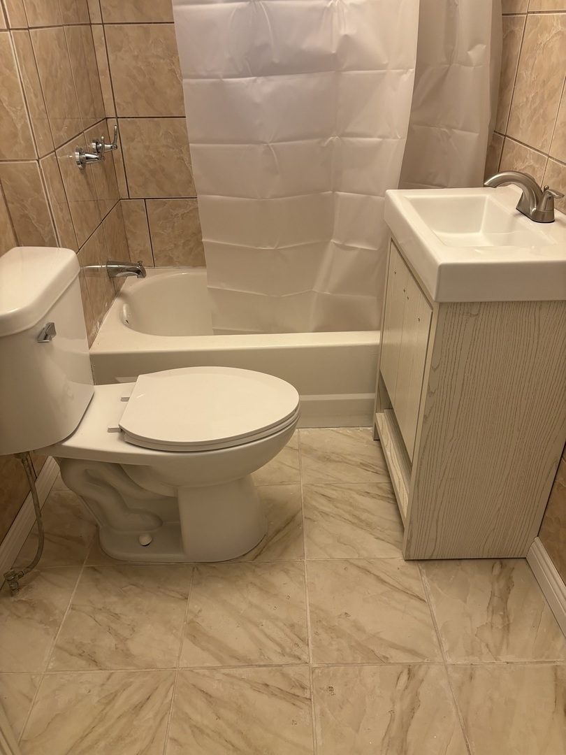 15634 Union Avenue Harvey, IL 60426 - Photo 14 of 34 a bathroom with a sink and a toilet