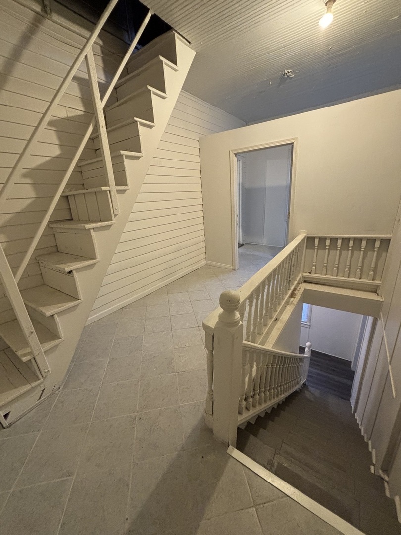15634 Union Avenue Harvey, IL 60426 - Photo 16 of 34 a view of staircase with white walls and windows