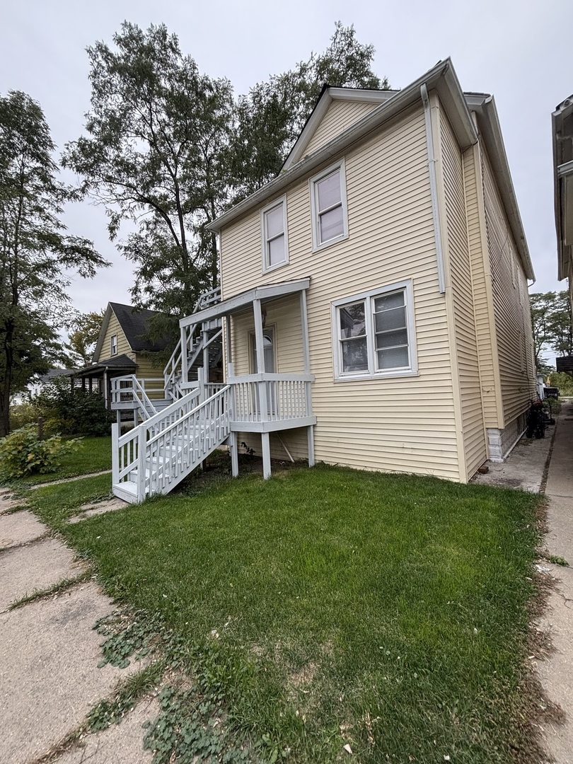 15634 Union Avenue Harvey, IL 60426 - Photo 32 of 34 a view of a house with a yard and sitting area