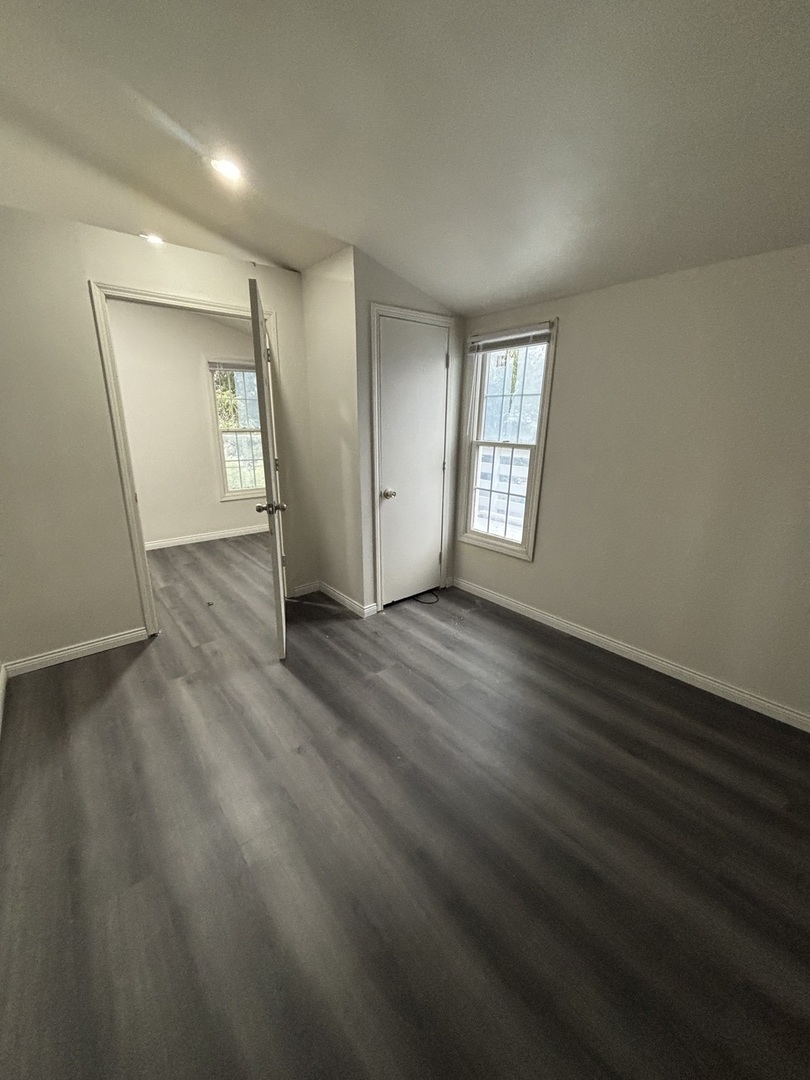 15634 Union Avenue Harvey, IL 60426 - Photo 8 of 34 an empty room with wooden floor and window