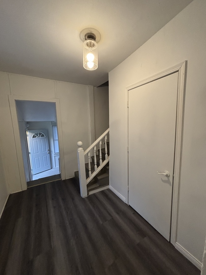 15634 Union Avenue Harvey, IL 60426 - Photo 10 of 34 an empty room with wooden floor front door and windows