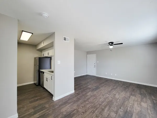 an empty room with wooden floor and a fireplace