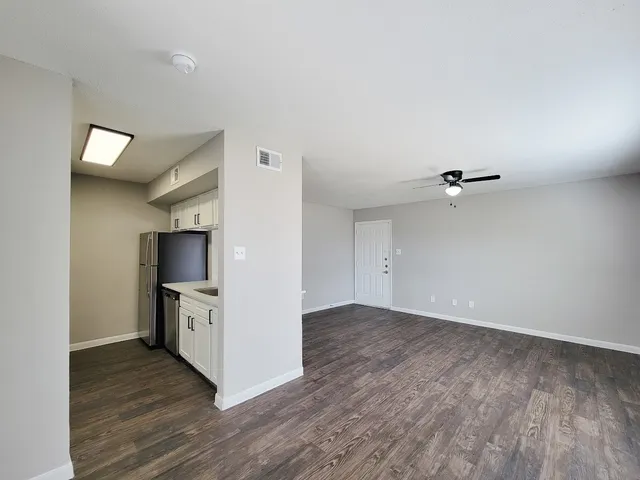 an empty room with wooden floor and a fireplace