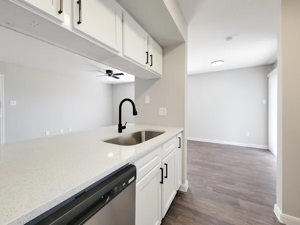 a kitchen with a sink and a refrigerator