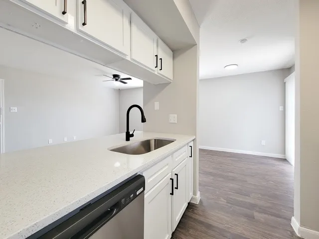 a kitchen with a sink and a refrigerator