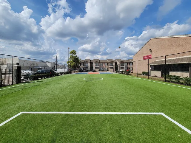 a view of yard with swimming pool and green space