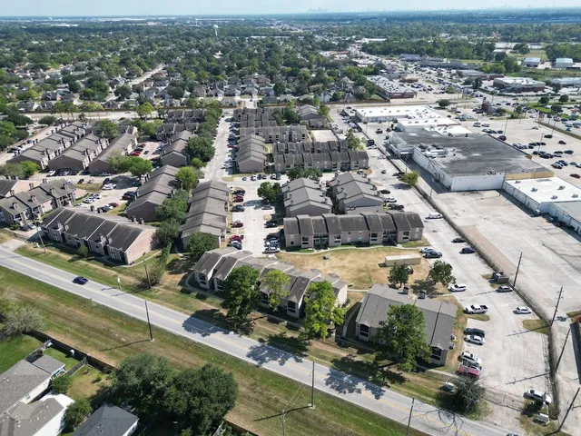 an aerial view of residential houses with city view