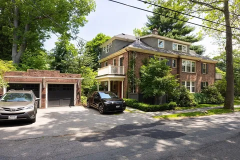 a view of a car parked in front of a brick house