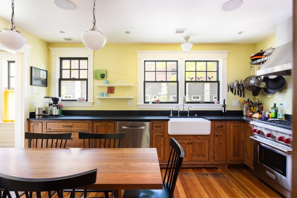 87 Greenough Street, Unit 2 Brookline, MA 02445 - Photo 7 of 23 a kitchen with kitchen island a dining table chairs and a sink
