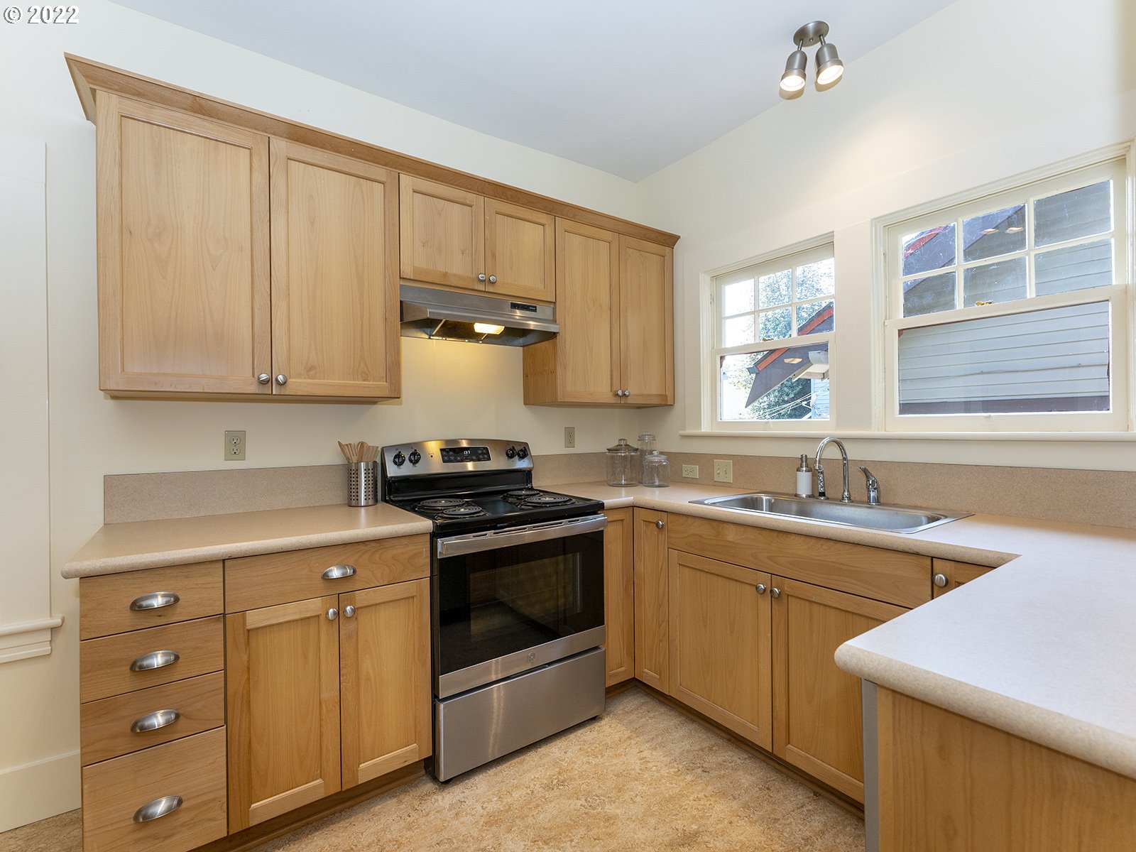 2424 Southeast Caruthers Street Portland, OR 97214 - Photo 11 of 32 a kitchen with stainless steel appliances granite countertop a sink stove and cabinets