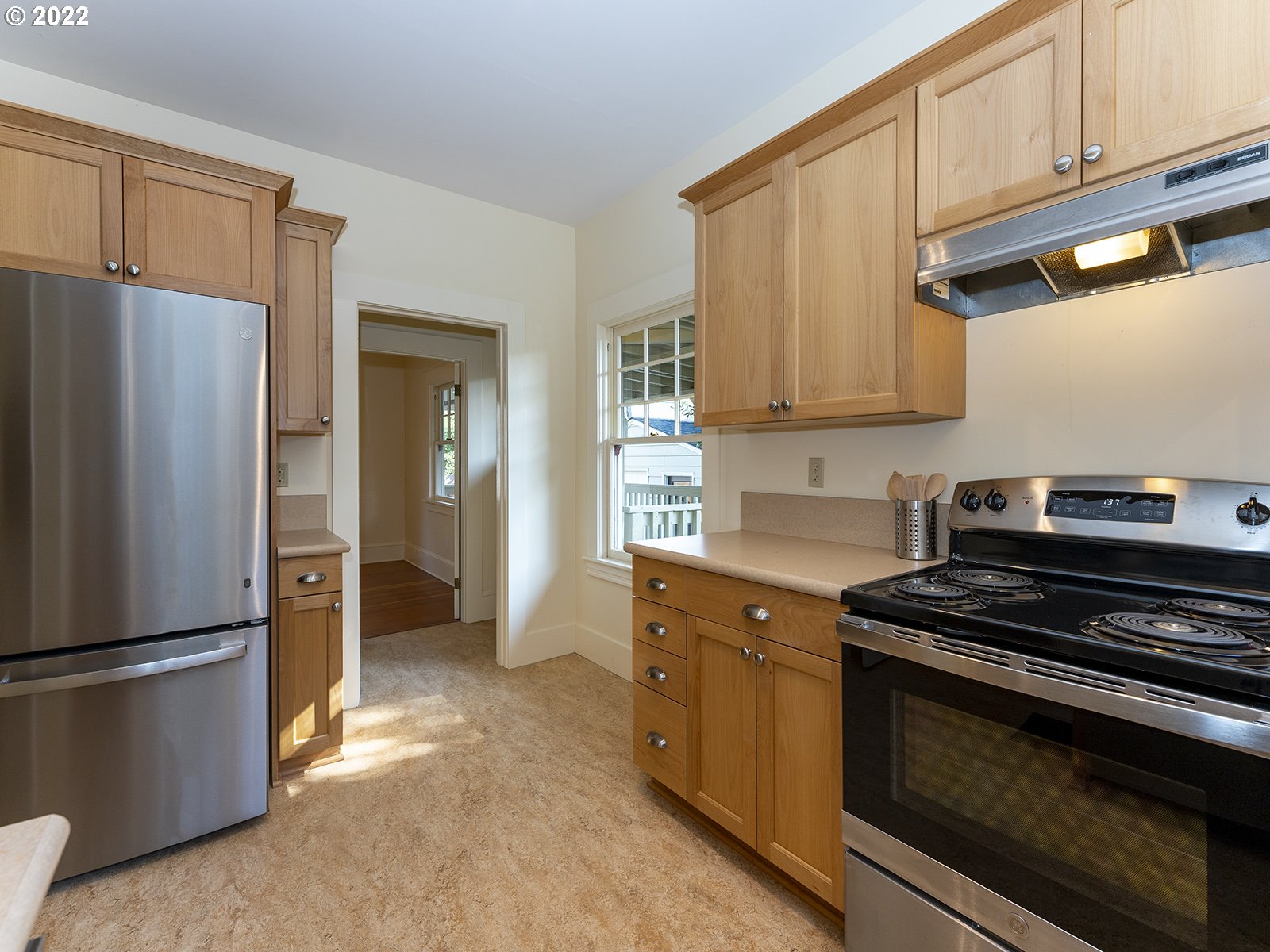 2424 Southeast Caruthers Street Portland, OR 97214 - Photo 12 of 32 a kitchen with stainless steel appliances granite countertop a refrigerator stove and cabinets