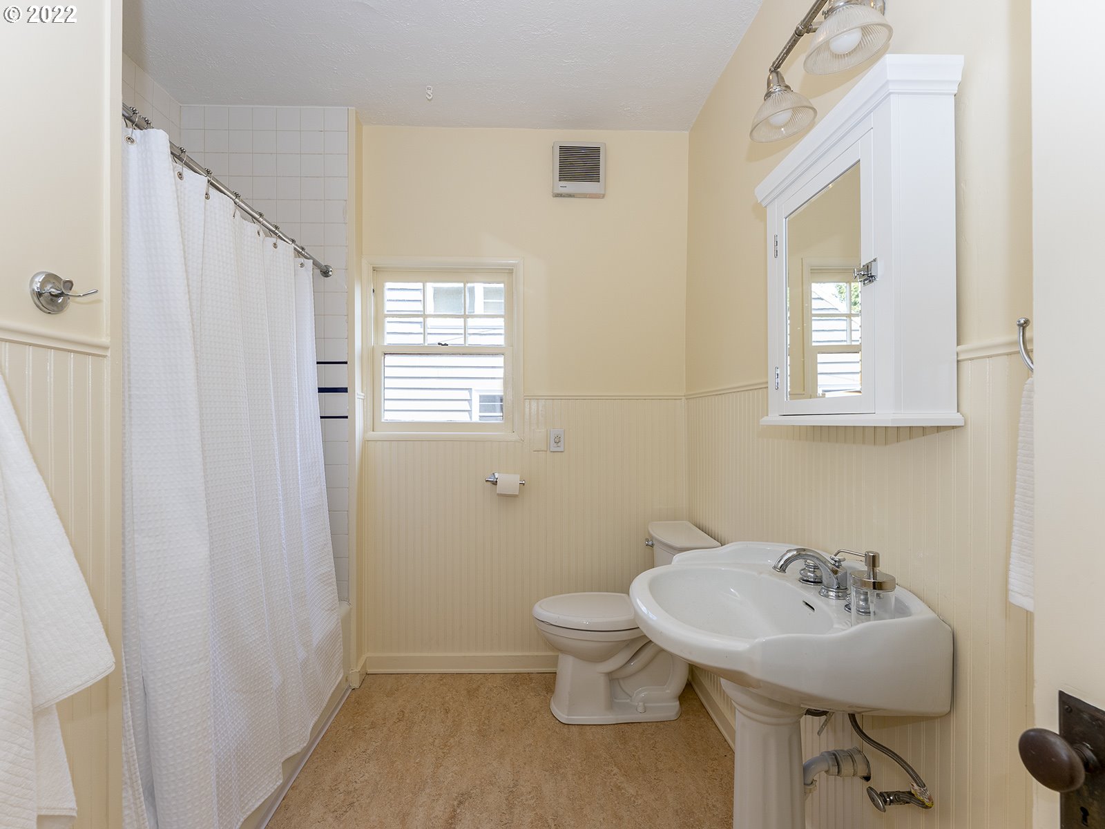2424 Southeast Caruthers Street Portland, OR 97214 - Photo 14 of 32 a bathroom with a sink a toilet and a mirror