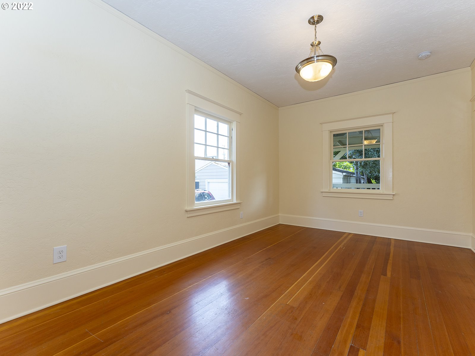2424 Southeast Caruthers Street Portland, OR 97214 - Photo 15 of 32 wooden floor in an empty room with a window