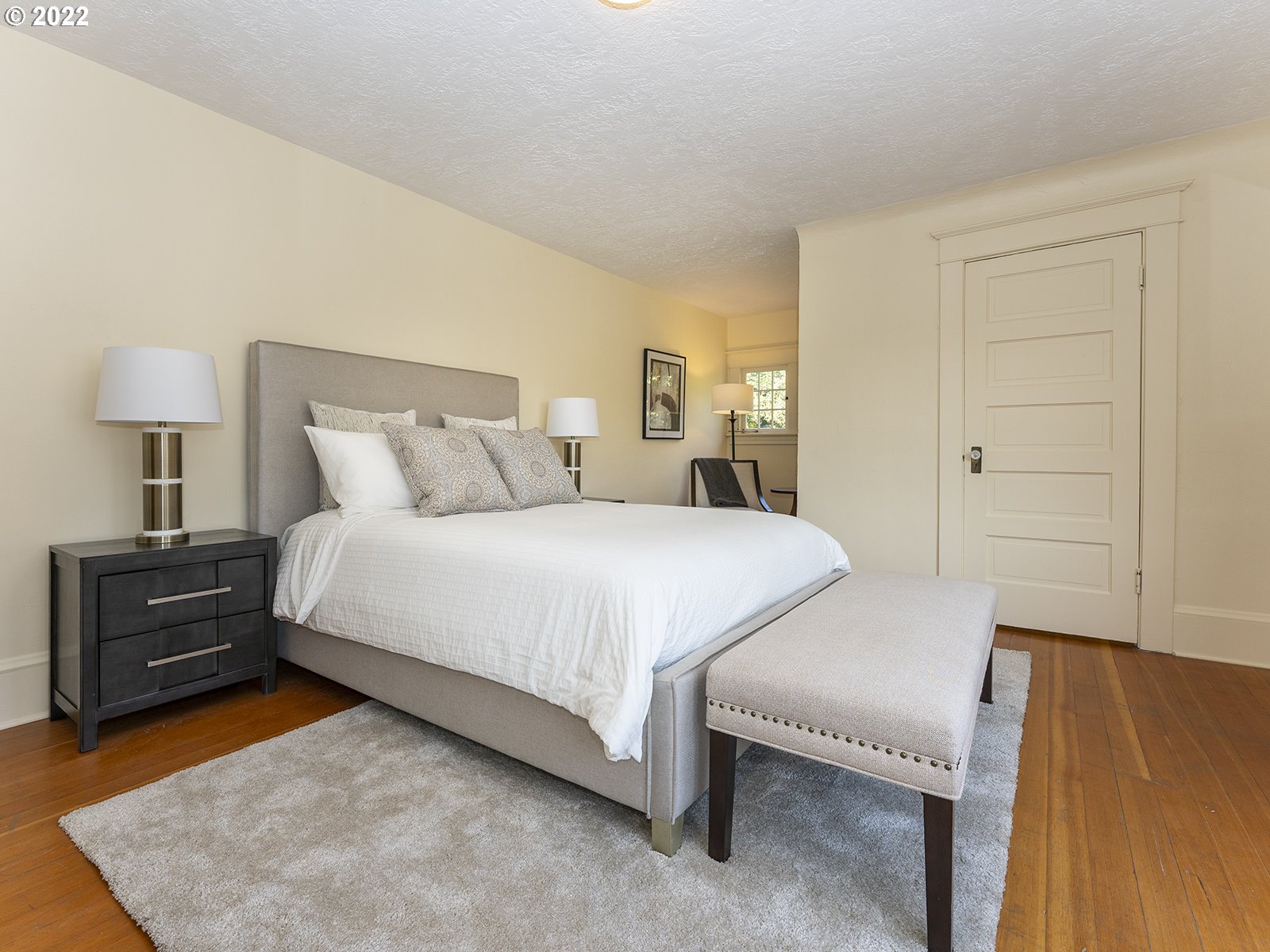 2424 Southeast Caruthers Street Portland, OR 97214 - Photo 17 of 32 a bedroom with a bed and a night stand