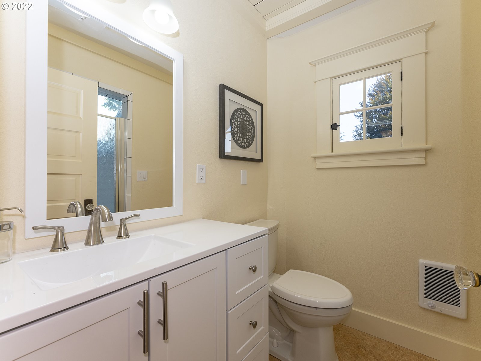 2424 Southeast Caruthers Street Portland, OR 97214 - Photo 20 of 32 a bathroom with a toilet a sink and mirror
